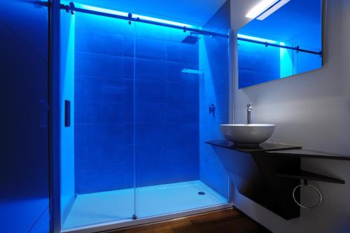 a bathroom with a glass shower with a sink at Urban Trend - Guest House in Palmanova