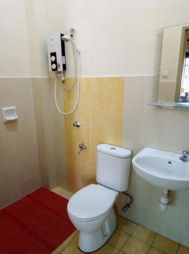 a bathroom with a toilet and a sink at Muslim 2 Stay in Melaka