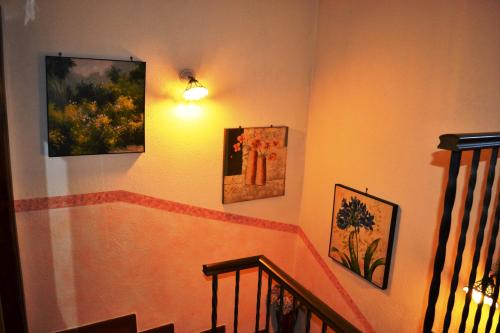 a staircase with three pictures on the wall at La Giara Bed&Breakfast in Brienza
