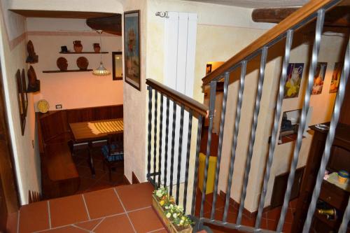 a hallway with a staircase and a dining room at La Giara Bed&Breakfast in Brienza