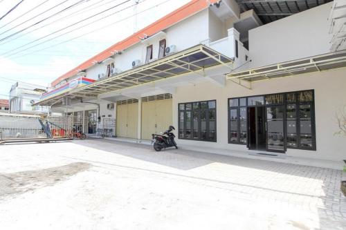 a motorcycle parked in front of a building at RedDoorz near Jogja Kembali Monument 3 in Kalasan