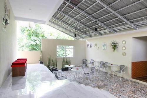 a large room with chairs and tables in it at RedDoorz near Jogja Kembali Monument 3 in Kalasan