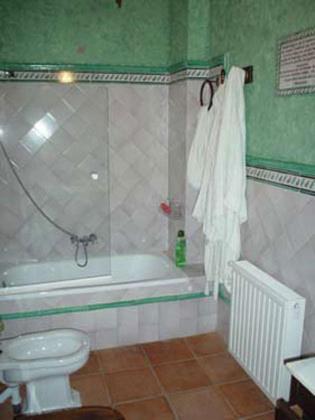 a bathroom with a tub and a toilet and a shower at Vivienda Turística Alojamiento Rural EL Trillo in El Alcornocal