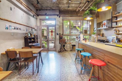 a restaurant with tables and chairs and a counter at Bao Cheng Home in Tainan