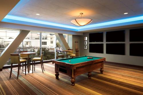 a billiard room with a pool table and chairs at Hyatt Regency Dallas in Dallas