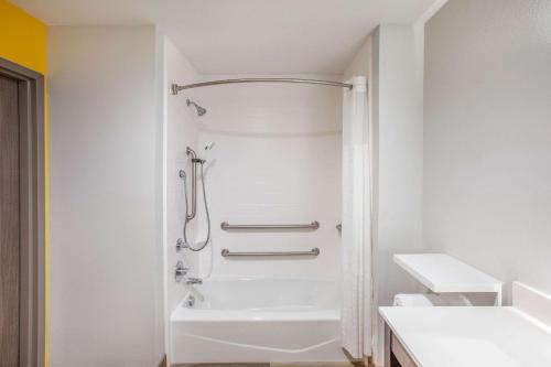 a white bathroom with a shower and a tub at La Quinta by Wyndham Dallas Duncanville in Duncanville