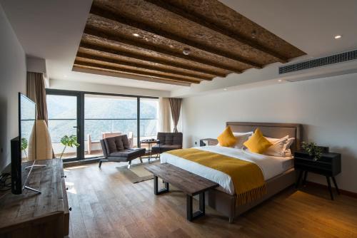 a bedroom with a large bed with a wooden ceiling at The Western Clouds in Deqing