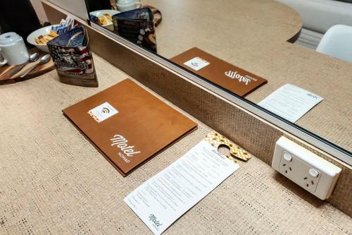 a desk with a mirror and some notes on it at Motel Nomad in Cairns