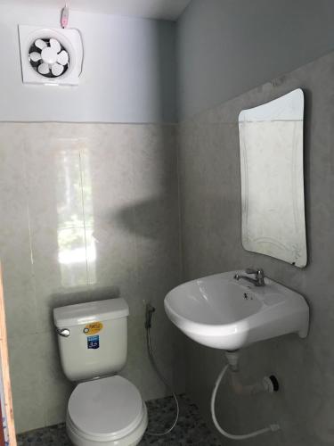 a small bathroom with a toilet and a sink at The Small Guest House in Koh Rong Island