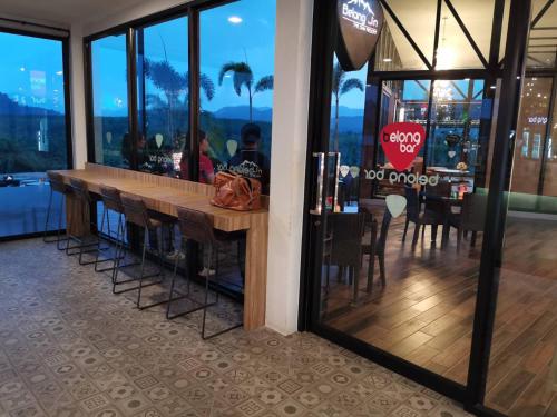 a bar in a restaurant with a view of the city at Belong Jin The Dam Hotel And Resort in Ban Pha Saeng Lang