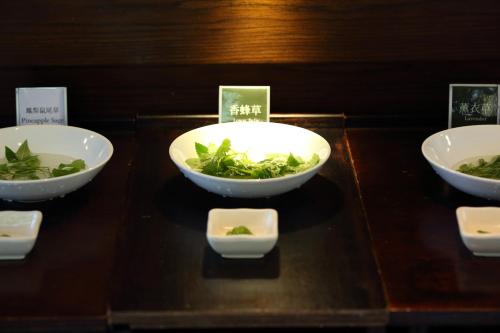 three bowls with greens in them on a table at Grace Garden Villa in Fengshan