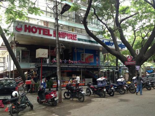 a group of motorcycles parked in front of a hotel at Hotel Noor Empire International Kormangala in Bengaluru