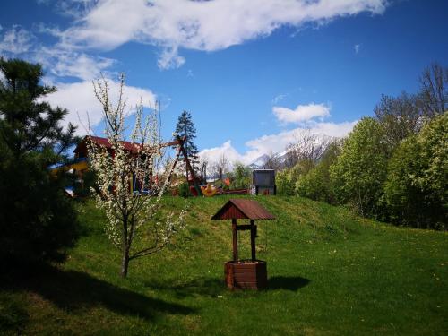 a small structure in a field with a tree at Villa Gold in Nová Lesná