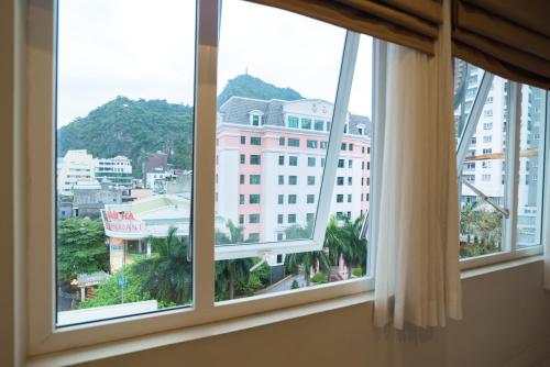 an open window with a view of a city at London Hotel in Ha Long