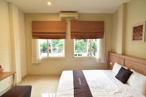 a bedroom with a large bed and a window at London Hotel in Ha Long