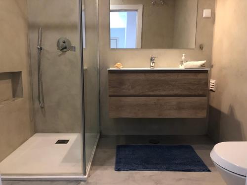 a bathroom with a shower and a sink and a toilet at Casa Moinhos do Mar in Ericeira
