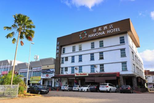 un hotel con coches aparcados delante en Havona Hotel - Kulai, en Kulai