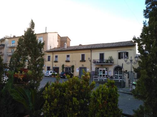 a building with cars parked in a parking lot at La casa dei Fiori in Vetralla
