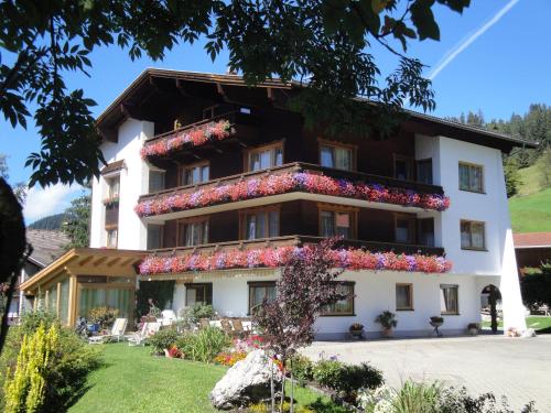 a building with flowers on the side of it at Apartment Austria in Tannheim