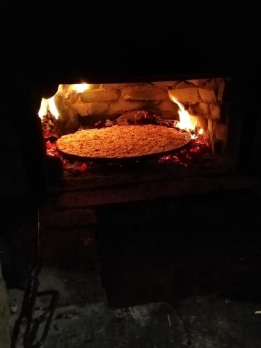 a pizza is being cooked in an oven at Apartment Raya in Sapareva Banya