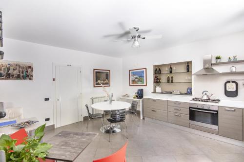 a kitchen with a table and a ceiling fan at B&B Porta delle Madonie in Campofelice di Roccella