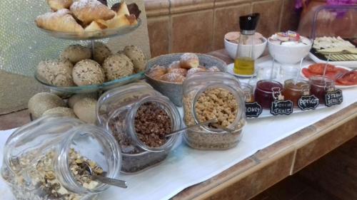 a buffet filled with different types of food on a counter at BYPILLOW Villa Lorena Adults Recommended in Málaga