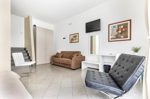 a living room with a couch and a chair at B&B Porta delle Madonie in Campofelice di Roccella