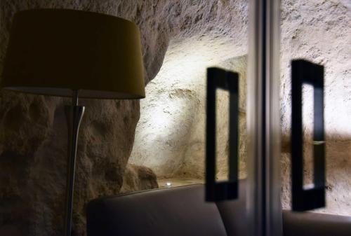 a lamp sitting next to a window in a room at 5 Elementi Sassi Matera in Matera