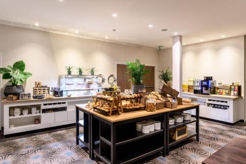 a store with a counter with food on it at Leopold Hotel Oudenaarde in Oudenaarde