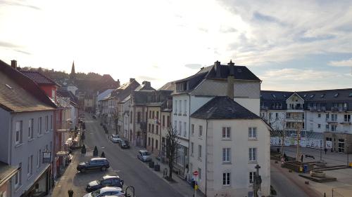 a view of a city street with buildings and cars at Hotel-Restaurant Beim Schlass in Wiltz