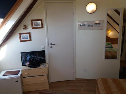 a room with a white door and a tv and a staircase at Sunrise majutus in Pärnu