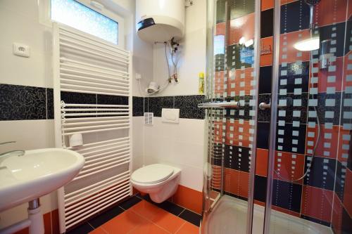 a bathroom with a toilet and a sink and a shower at Azalka Penzion in Brno