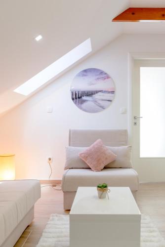 a white living room with a couch and a table at Apartments Villa Tudor in Hvar