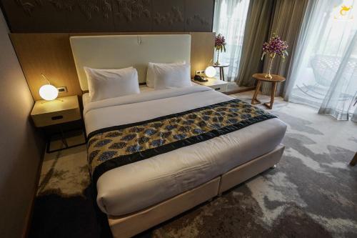 a bedroom with a large bed in a hotel room at Clarks Inn Suites Raipur in Raipur
