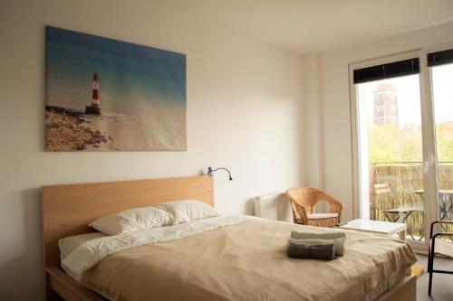 a bedroom with a bed and a picture of a lighthouse at Navel Studio by Little Heaven in Gdańsk