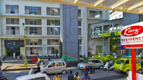 a group of cars and people on a city street at Kenz Residency in Cochin