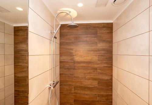 a shower stall in a bathroom with wooden tiles at P54 Apartment in Paide