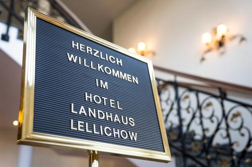 a sign for a hotel in london and a balcony at Landhaus Lellichow in Lellichow