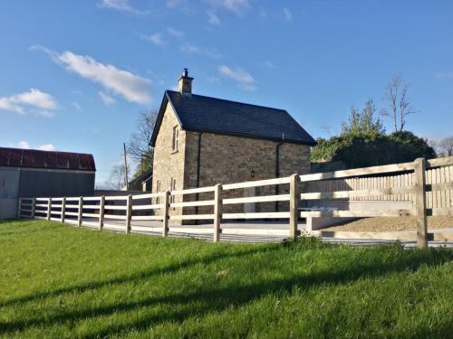 a wooden fence in front of a barn at Knockninny Barn at Upper Lough Erne, County Fermanagh in Enniskillen