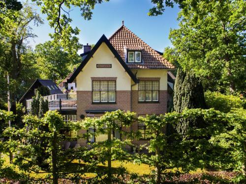a house in the middle of a yard with trees at Villa 1913 in Bergen
