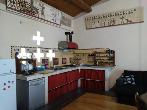 a kitchen with a stove and a sink and a refrigerator at Antico Casale dei Sogni agriturismo in Lugo