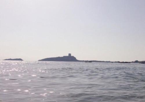 an island in the water with a lighthouse on it at Sophie Home - Comfort e Relax a pochi km da Nora in Pula