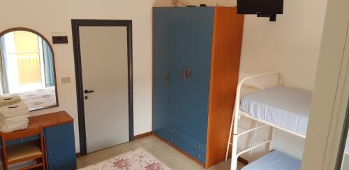 a bedroom with a bunk bed and a desk and a door at B&B Villa Rocchi in Rimini