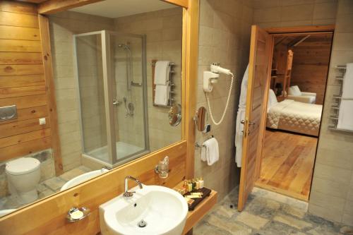 a bathroom with a sink and a shower and a toilet at Bianca Resort & Spa in Kolašin