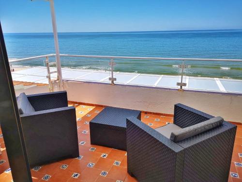 a view of the ocean from the balcony of a building at A la Orilla del Mar in Matalascañas