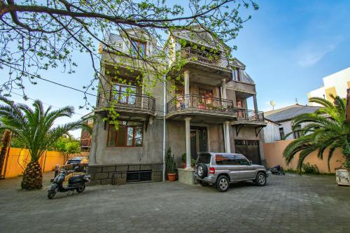 a car parked in front of a house at NaNa's Guesthouse in Batumi