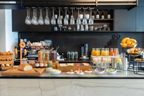 a kitchen with a counter with food and drinks at Conscious Hotel Museum Square in Amsterdam