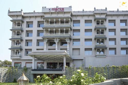 a large white building with a sign on it at Clarks Inn Suites Raipur in Raipur