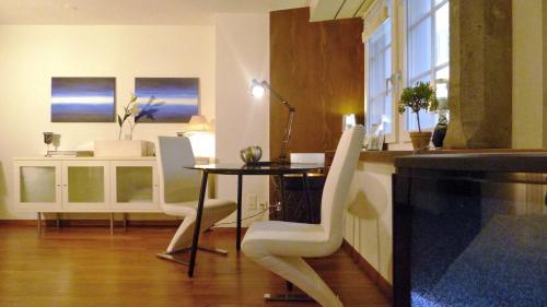 a kitchen with a table and chairs and a dining room at In the heart of Zurich - pedestrian area - close to central, main train station and riverside in Zürich