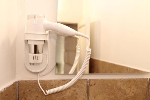 a white phone on a wall with a mirror at Suite dei Longobardi in Lecce